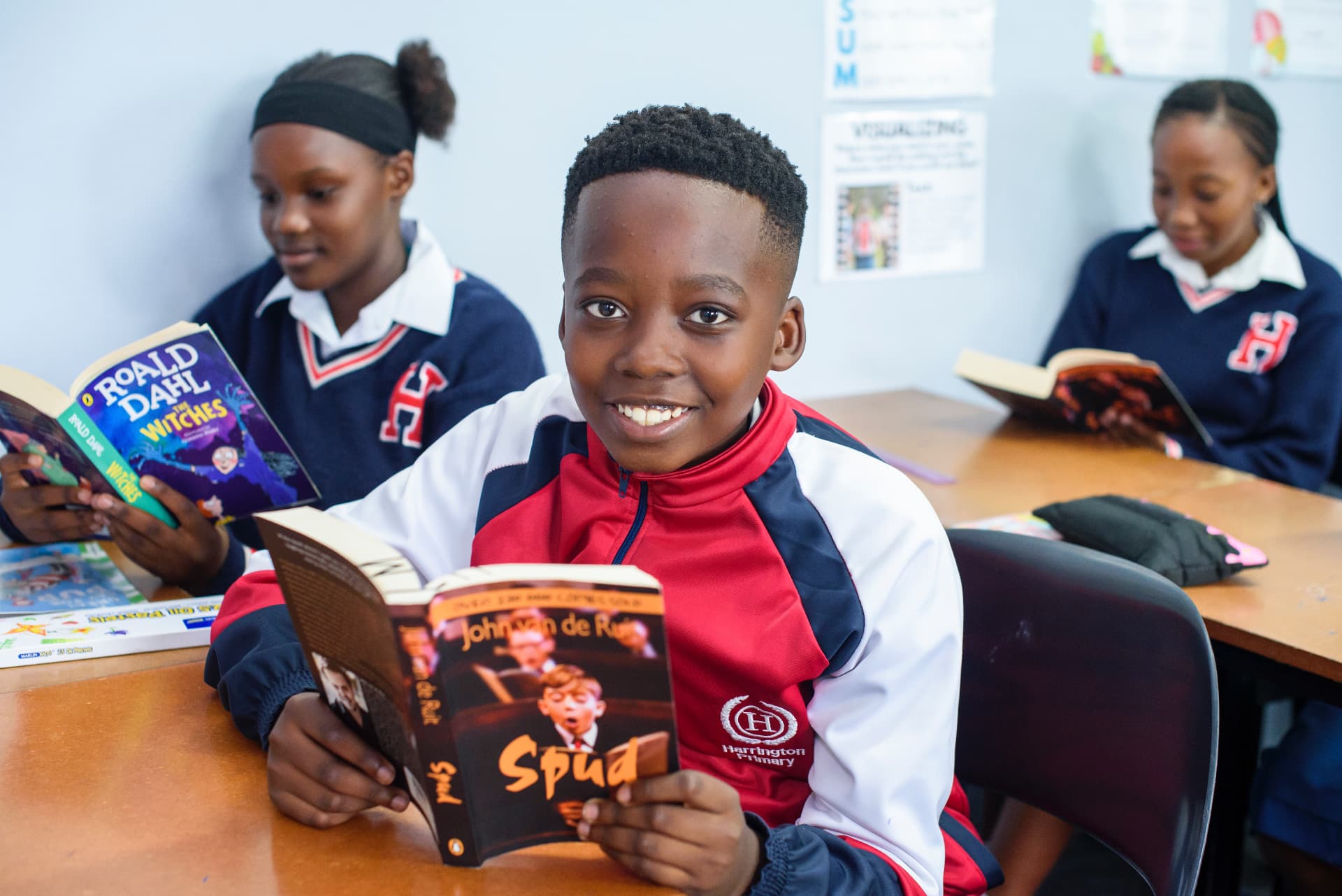 A Harrington pupil enjoying a book during reading time