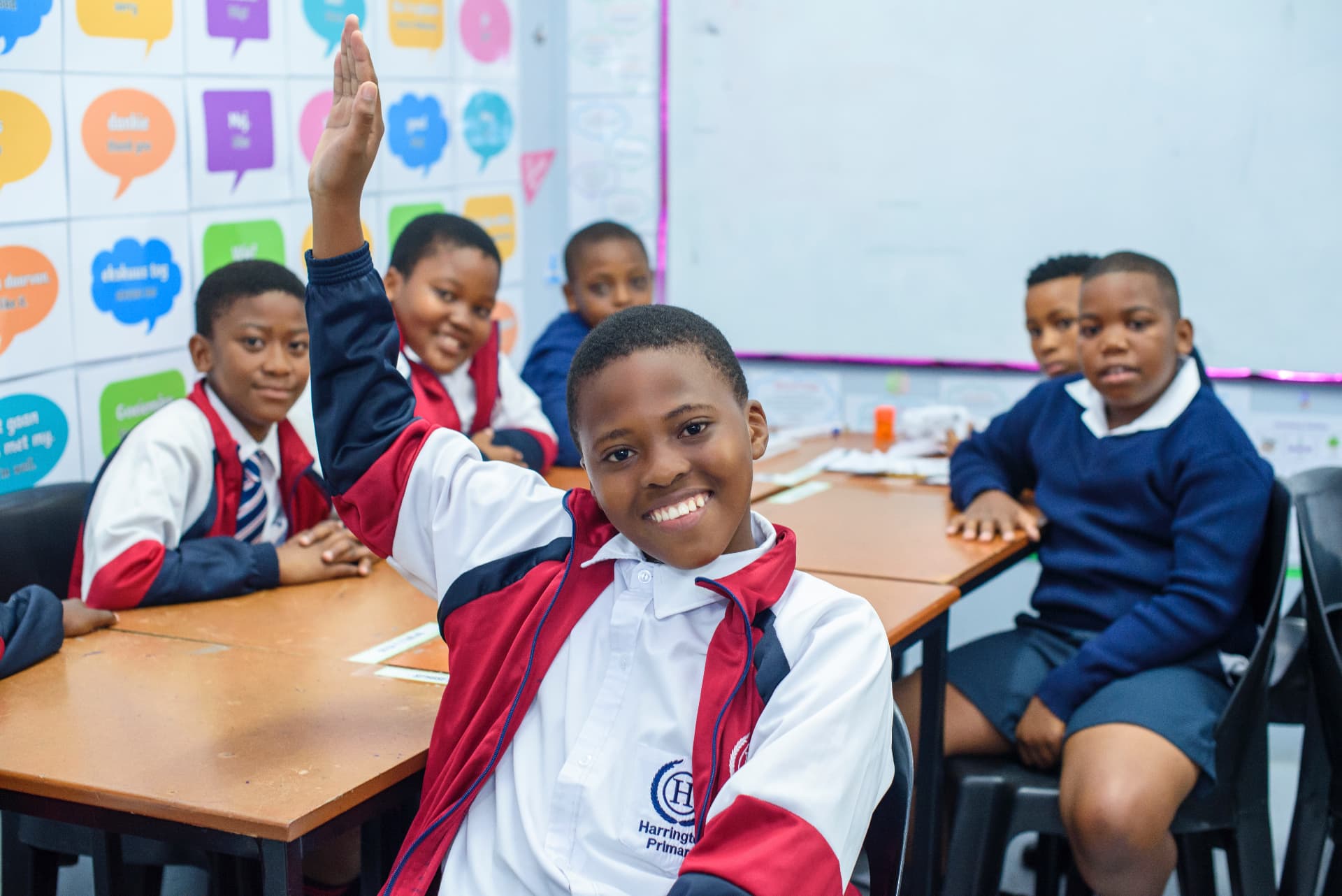 Harrington pupils eagerly raising their hands in class